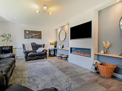 a living room with a couch and a fireplace at 3 Bed in Bude oc-09117 in Saint Gennys