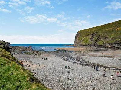 a group of people on a beach near the ocean at 3 Bed in Bude oc-09117 in Saint Gennys