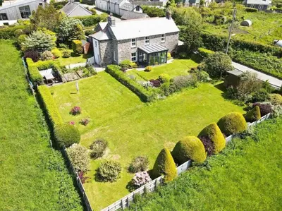 an aerial view of a house with a garden at Beautiful family home, sea views, large garden in Port Isaac