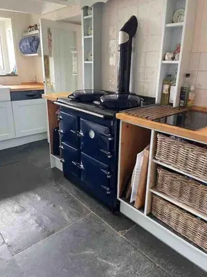 a kitchen with a blue stove in a kitchen at Beautiful family home, sea views, large garden in Port Isaac
