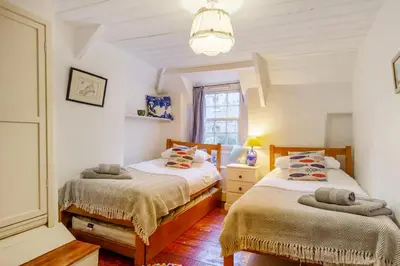 a bedroom with two beds and a window at 3 Bed in Little Petherick oc-balcot in Little Petherick
