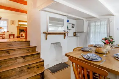 a kitchen and dining room with a wooden table at 3 Bed in Little Petherick oc-balcot in Little Petherick