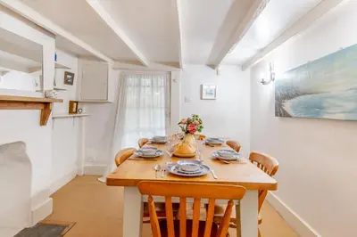 a dining room with a wooden table and chairs at 3 Bed in Little Petherick oc-balcot in Little Petherick