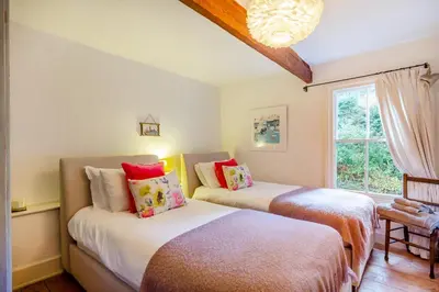 two beds in a room with a window at 3 Bed in Little Petherick oc-balcot in Little Petherick