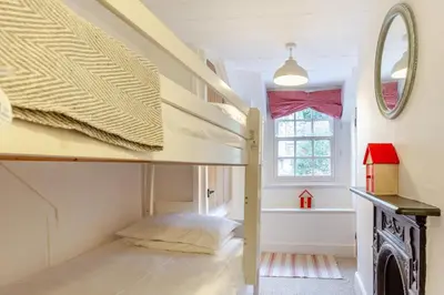 a bedroom with two bunk beds and a window at 2 Bed in Little Petherick oc-w28425 in Little Petherick