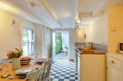 a kitchen with a table and chairs and a counter top at 2 Bed in Little Petherick oc-w28425 in Little Petherick