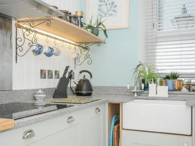 a kitchen with a sink and a counter top at Zawn Nook in Falmouth