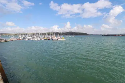 a group of boats are docked in a harbor at Zawn Nook in Falmouth