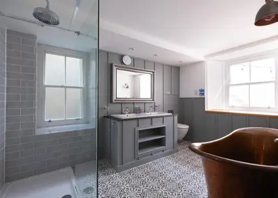 a bathroom with a sink and a mirror at Georgian Apartment with Courtyard in Boscastle - Ideal for Couples and Families in Boscastle