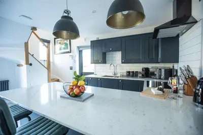 a kitchen with a counter with a bowl of fruit on it at THE ANNEXE AT UPPER BEACH HOUSE in Portreath