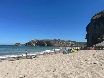 a group of people on a beach near the ocean at THE ANNEXE AT UPPER BEACH HOUSE in Portreath