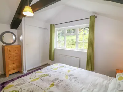 a bedroom with a bed and a window at The Granary in Bodmin