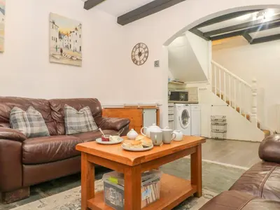 a living room with a couch and a table at The Granary in Bodmin