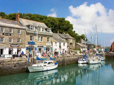 a group of boats are docked in a harbor at The Granary in Bodmin