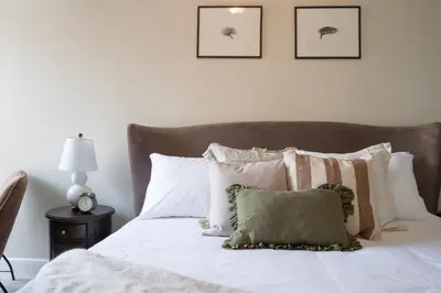 a bedroom with a bed with white sheets and pillows at The King Of Prussia in Fowey