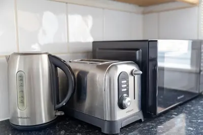 a toaster oven and a toaster oven with a toaster at Tolcarne Guest House in Newquay