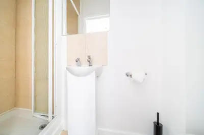 a bathroom with a sink and a shower at Tolcarne Guest House in Newquay