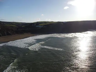 an aerial view of a beach with the ocean at Penmor in Bude