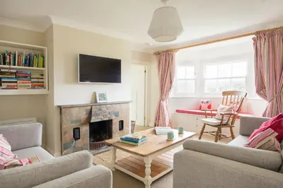 a living room with a couch and a fireplace at St Edwards Cottage, Tintagel in Tintagel