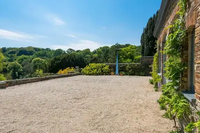 an empty courtyard of a brick building with trees at Lostwithiel Manor in Braddock