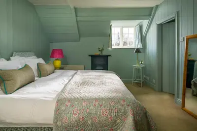 a bedroom with a large bed and a window at Lostwithiel House in Braddock