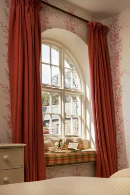 a window with red curtains in a bedroom at Lostwithiel House in Braddock