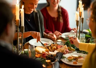 a group of people sitting around a table eating food at Lostwithiel House in Braddock