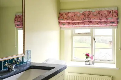 a bathroom with a sink and a window at Lostwithiel Dairy House in Braddock