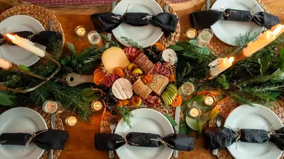 a table with plates of food and candles on it at Lostwithiel Dairy House in Braddock