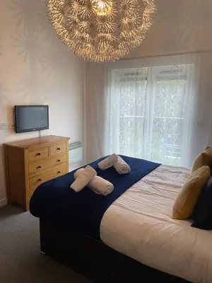 a bedroom with a bed with two towels on it at Valentyne Beach House in Porthtowan