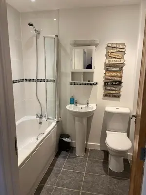 a bathroom with a toilet and a sink and a shower at Valentyne Beach House in Porthtowan