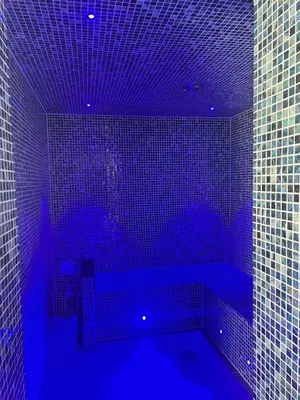 a blue bathroom with a tub with blue lighting at Delightful two bedroom caravan on Par Beach. in Par