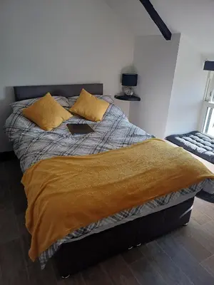 a bedroom with a bed with a laptop on it at Commercial Inn in Saint Dennis