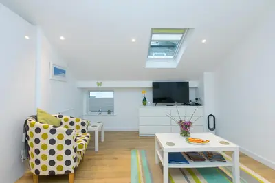 a living room with a couch and a table at Whitecaps in St Ives