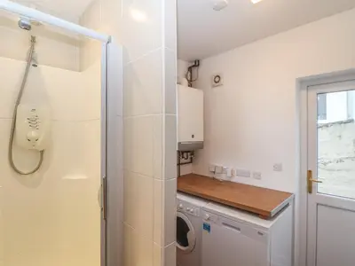 a laundry room with a washer and dryer at The Mordon in Newquay