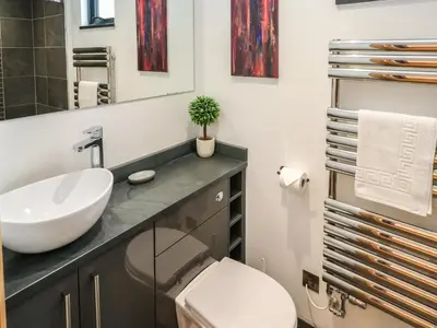 a bathroom with a sink and a toilet at Rooftops in St Ives