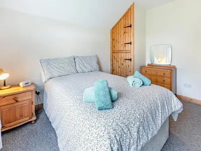 a bedroom with a bed with blue stuffed animals on it at Country View in Saint Erth