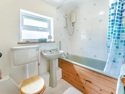 a bathroom with a sink and a toilet and a tub at Country View in Saint Erth