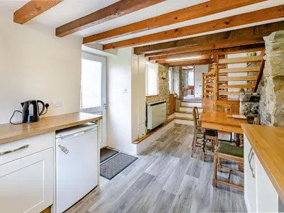 a kitchen and dining room with a table and chairs at Country View in Saint Erth