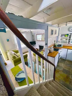 a kitchen and living room in a tiny house at A Cosy Period Family Cottage in St Ives Town, sleeps 4, pet friendly in St Ives