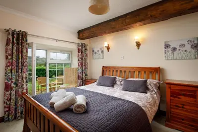 a bedroom with a bed with towels on it at Lanjew Park in Bodmin