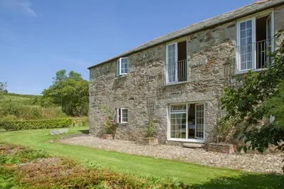 an old stone house with a green yard at Lanjew Park in Bodmin