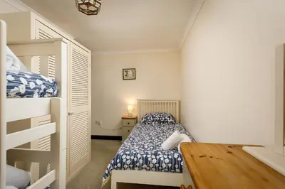 a small bedroom with a bed and bunk beds at Lanjew Park in Bodmin