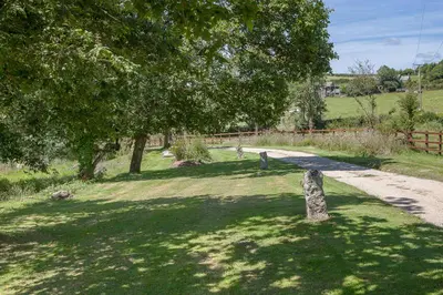 a park with a tree and a path at Lanjew Park in Bodmin