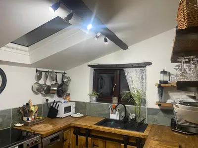 a kitchen with a sink and a counter top at Horseshoe Cottage in Looe