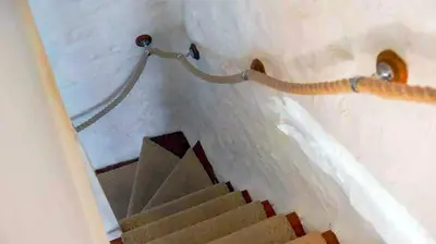 a staircase in a house with a stair case at St Ives fisherman cottage, Sleeps 5, pet friendly in St Ives
