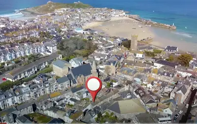 an aerial view of a city with a red marker at St Ives fisherman cottage, Sleeps 5, pet friendly in St Ives