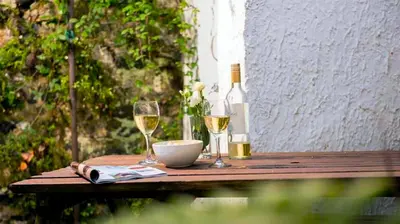 a table with two glasses of wine and a bowl at St Ives fisherman cottage, Sleeps 5, pet friendly in St Ives