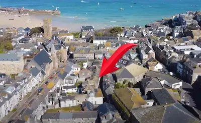 an aerial view of a city with a red arrow at St Ives fisherman cottage, Sleeps 5, pet friendly in St Ives