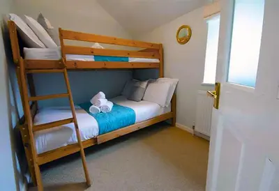 a bedroom with a bunk bed with a ladder at St Ives fisherman cottage, Sleeps 5, pet friendly in St Ives